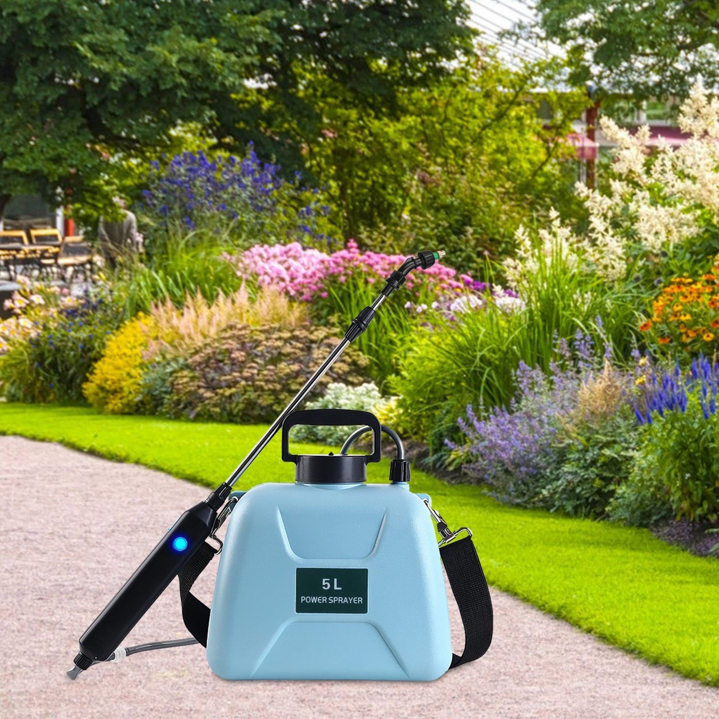Blue electric plant sprayer on a garden path with flowers and greenery in the background